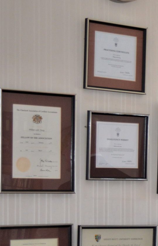 Framed professional certificates on the wall of the Ritson Young office
